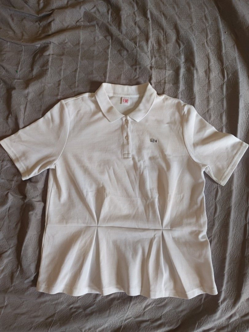 Lacoste L!VE White Polo Shirt (Category: Tshirts & Polo Shirts ) located in Cabuyao City. Submitted by bentleyboy_fire (Listing ID 1439223106, Image 3). Description: 1k+sf Excellent Condition White Lacoste L!VE polo shirt - Features the iconic crocodile logo - Pleated waist design - Size: L on tag - Dimes: L: 25 W:20 - Made in China - Fabric: 60% cotton, 40% polyester - Style number: DF4875 - Authentic - PSG OUT - Issue: minimal lints (barelynoti