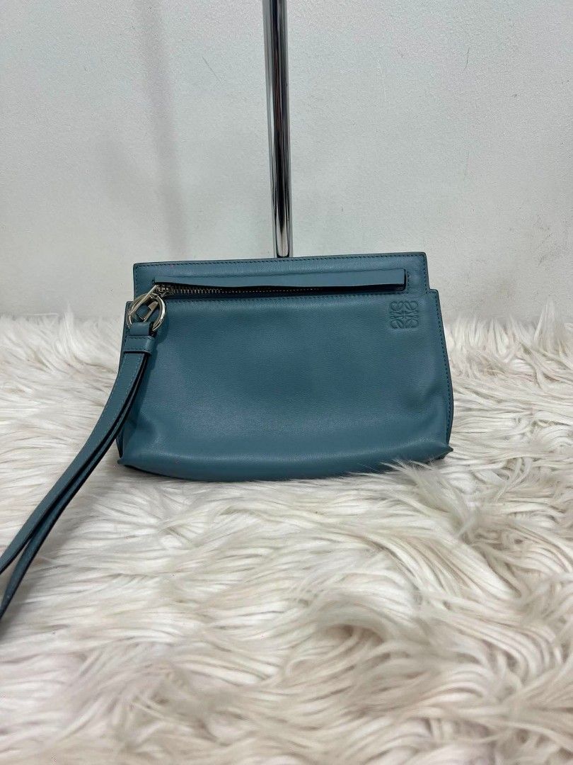 Loewe wristlet pouch (Category: Luxury Bags & Wallets) located in Manila. Submitted by rangya (Listing ID 1439140495, Image 2). Description: - Teal Loewe wristlet bag - Includes a wrist strap - Secure zippered top closure - Stylish silver-tone ring detail - Interior pocket with Loewe label - Made in Spain jm.