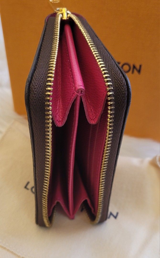 Louis Vuitton Compact Zip Vivienne (Category: Luxury Bags & Wallets) located in Quezon City. Submitted by bagsplusmore (Listing ID 1439248525, Image 3). Description: - Authentic Louis Vuitton zip wallet - Iconic Damier Ebene canvas - vivienne collection - Vibrant pink interior - Includes original box and dust bag - Multiple card and cash compartments .
