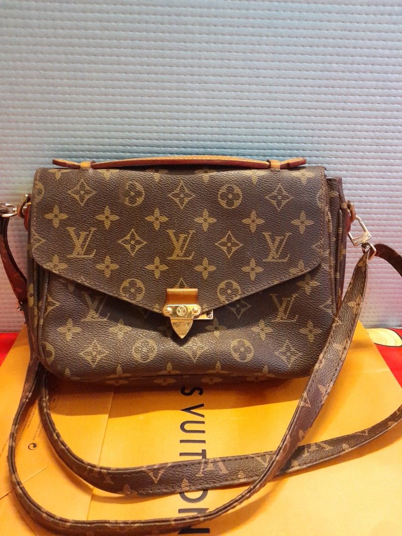 Louis Vuitton Monogram Crossbody Bag (Category: Bags & Wallets) located in Singapore. Submitted by vastcloud_ea17aa (Listing ID 1439098259, Image 1). Description: Louis Vuitton crossbody bag - Classic monogram canvas - Gold-tone clasp closure - Detachable shoulder strap - Top handle - Includes original shopping bag - Perfect for everyday use.