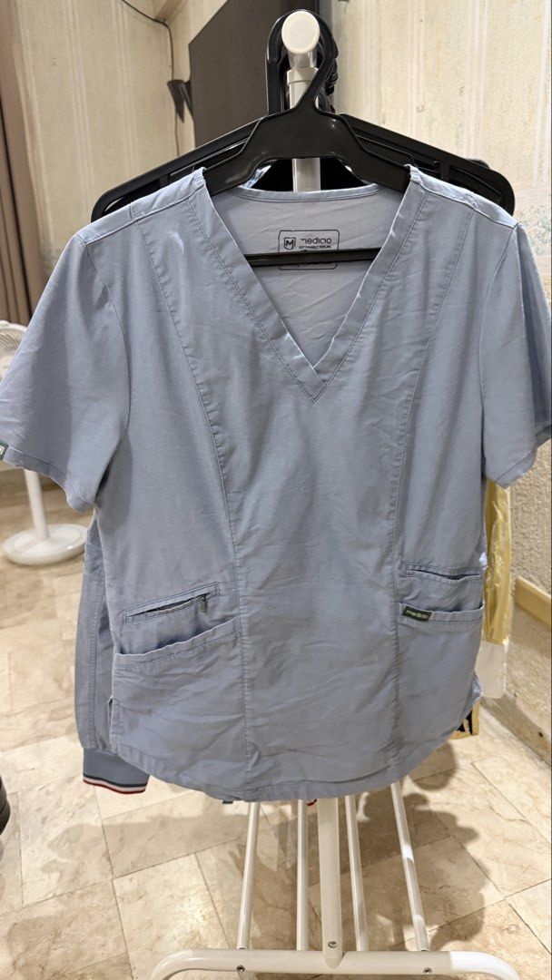 Mediclo Scrubs Set - Top and Pants (Category: Sets or Coordinates) located in Quezon City. Submitted by beabeys (Listing ID 1439130264, Image 3). Description: - Mediclo scrubs set super good condition - Light denim blue color - V-neck top with 2 pockets - Pants with drawstring waist and multiple pockets - Red accents on drawstring and ankles - Mediclo logo on top.