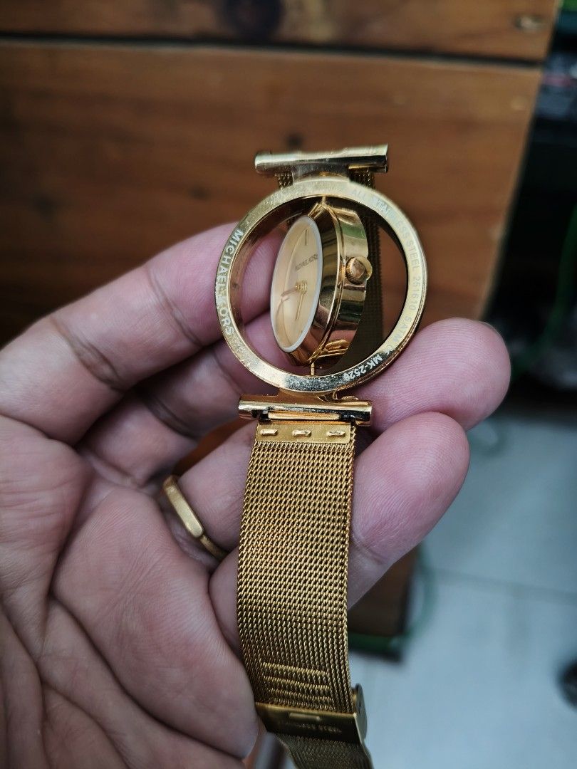 Michael Kors Gold Watch (Category: Women's Watches) located in Baguio. Submitted by marbd1971 (Listing ID 1439104638, Image 3). Description: - Michael Kors watch stainless gold watch - Gold-tone mesh strap - White-colored watch face - Gold hands and logo - Rotating bezel - Branded clasp with Michael Kors engraved into it. .
