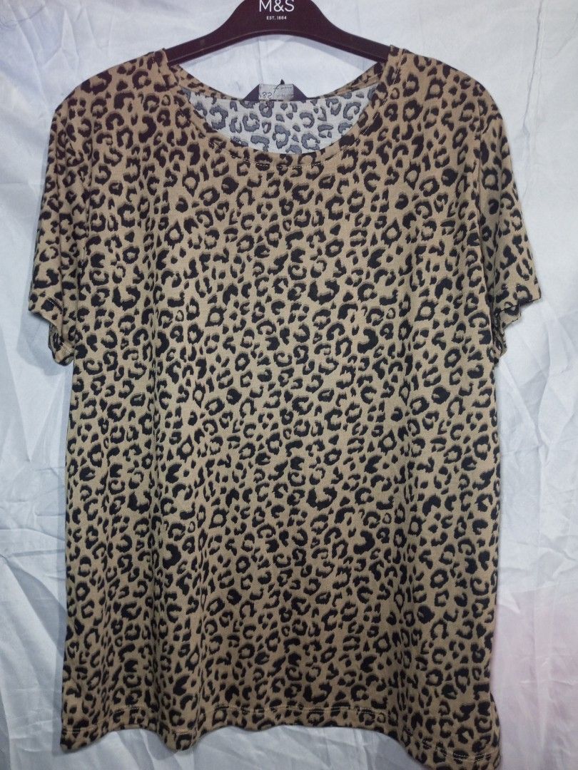 M&S Leopard Print T-shirt Size 12 (Category: Tshirts & Polo Shirts ) located in Quezon City. Submitted by czyrainkaye (Listing ID 1439180889, Image 1). Description: - M&S Leopard Print T-shirt - Size: 12 - Features a classic leopard print - Round neckline - Short sleeves - Made of soft material - Versatile for various outfits.