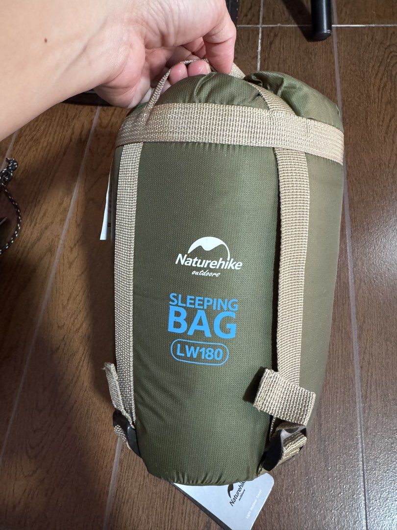 Naturehike LW180-M Sleeping Bag (Category: Hiking & Camping) located in Manila. Submitted by leimaraj0219 (Listing ID 1439147042, Image 2). Description: Naturehike LW180-M sleeping bag in Army Green. It is a mini envelope sleeping bag with dimensions of 190x75cm. The fabric is 20D/380T nylon, and the liner is 240T polyester pongee. It has a comfort temperature of 15°C. The sleeping bag is designed for outdoor use..