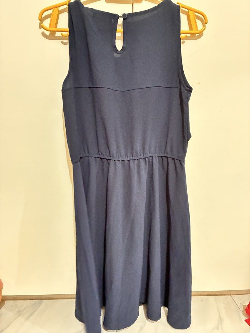 Navy Blue Sleeveless Dress (Category: Dresses) located in Marikina City. Submitted by liamcruz28 (Listing ID 1439158788, Image 2). Description: - Navy blue sleeveless dress - Round neckline - Layered bodice detail - Elasticated waist - Flared skirt - Keyhole back opening - Made of lightweight fabric - Versatile for various occasions.