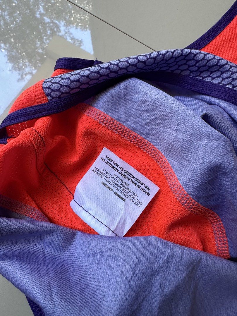 Nike Dri-Fit Running Tank Top - Small (Category: Activewear) located in Rosales. Submitted by dariang22 (Listing ID 1439091356, Image 2). Description: - Nike Dri-Fit running tank top - Color: Orange and purple - Size: Small - Racerback design - Made in Malaysia - Material: 100% polyester - Nike logo visible - Ideal for running and athletic activities.