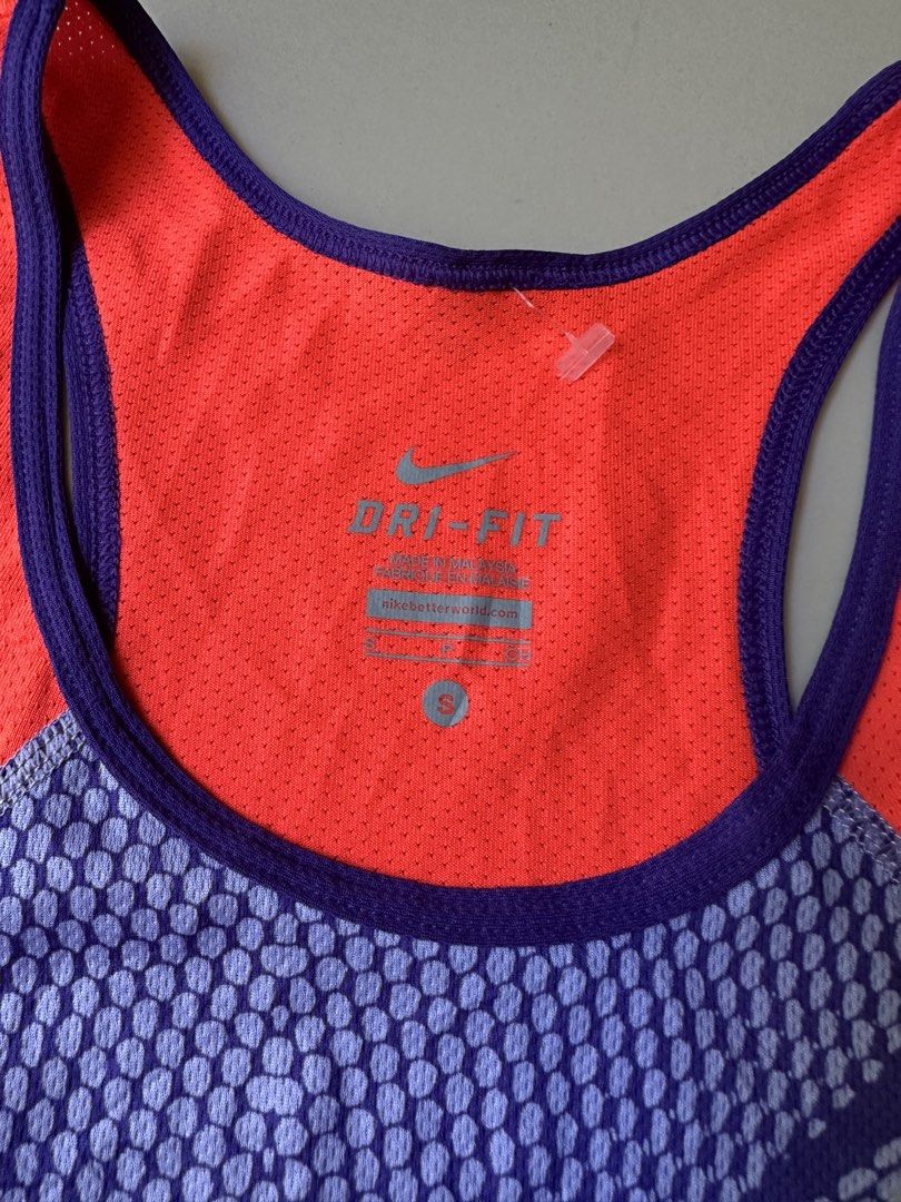 Nike Dri-Fit Running Tank Top - Small (Category: Activewear) located in Rosales. Submitted by dariang22 (Listing ID 1439091356, Image 3). Description: - Nike Dri-Fit running tank top - Color: Orange and purple - Size: Small - Racerback design - Made in Malaysia - Material: 100% polyester - Nike logo visible - Ideal for running and athletic activities.