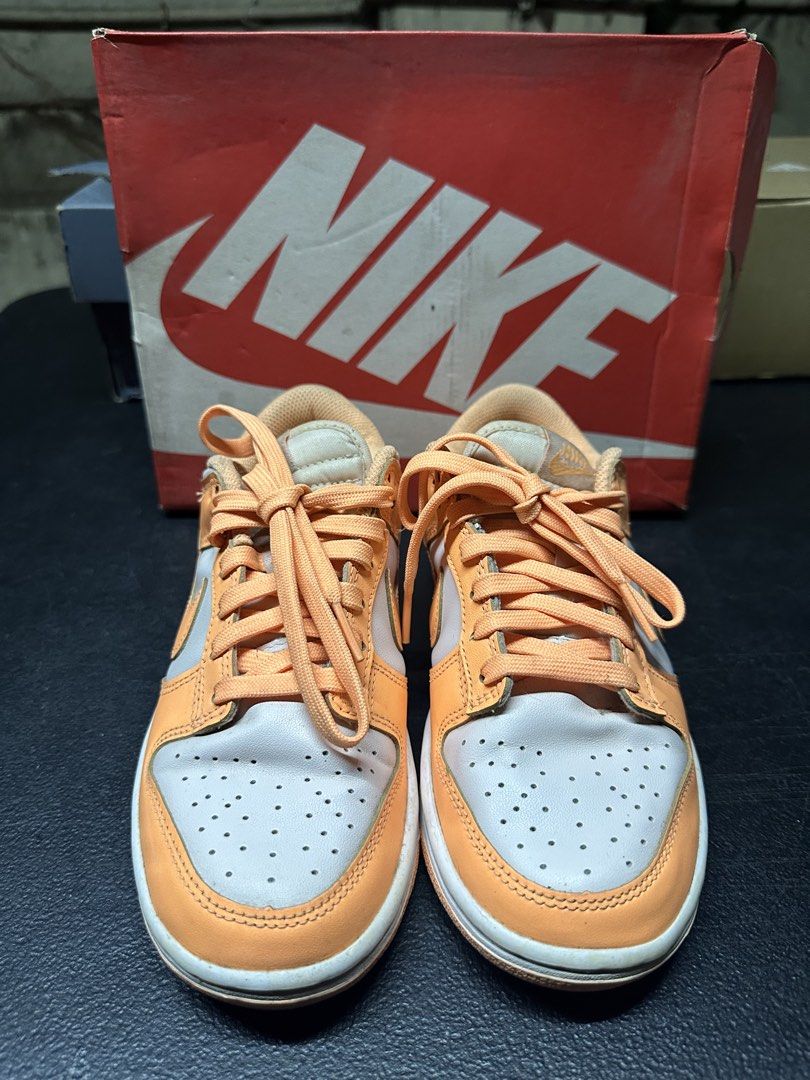 Nike Dunk Low Peach Cream (Category: Sneakers) located in Quezon City. Submitted by plzdeclutter (Listing ID 1439218810, Image 2). Description: - Nike Dunk Low - Color: Orange and Light Grey - Size: EUR 36, CM 22.5, US 5.5 - Features Nike logo and embroidered "NIKE" on heel - Includes original box - Just needs cleaning - No issue -Worn few times.