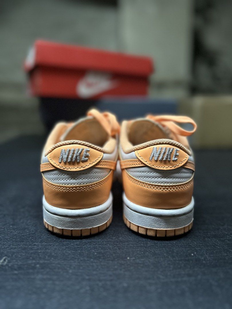 Nike Dunk Low Peach Cream (Category: Sneakers) located in Quezon City. Submitted by plzdeclutter (Listing ID 1439218810, Image 3). Description: - Nike Dunk Low - Color: Orange and Light Grey - Size: EUR 36, CM 22.5, US 5.5 - Features Nike logo and embroidered "NIKE" on heel - Includes original box - Just needs cleaning - No issue -Worn few times.