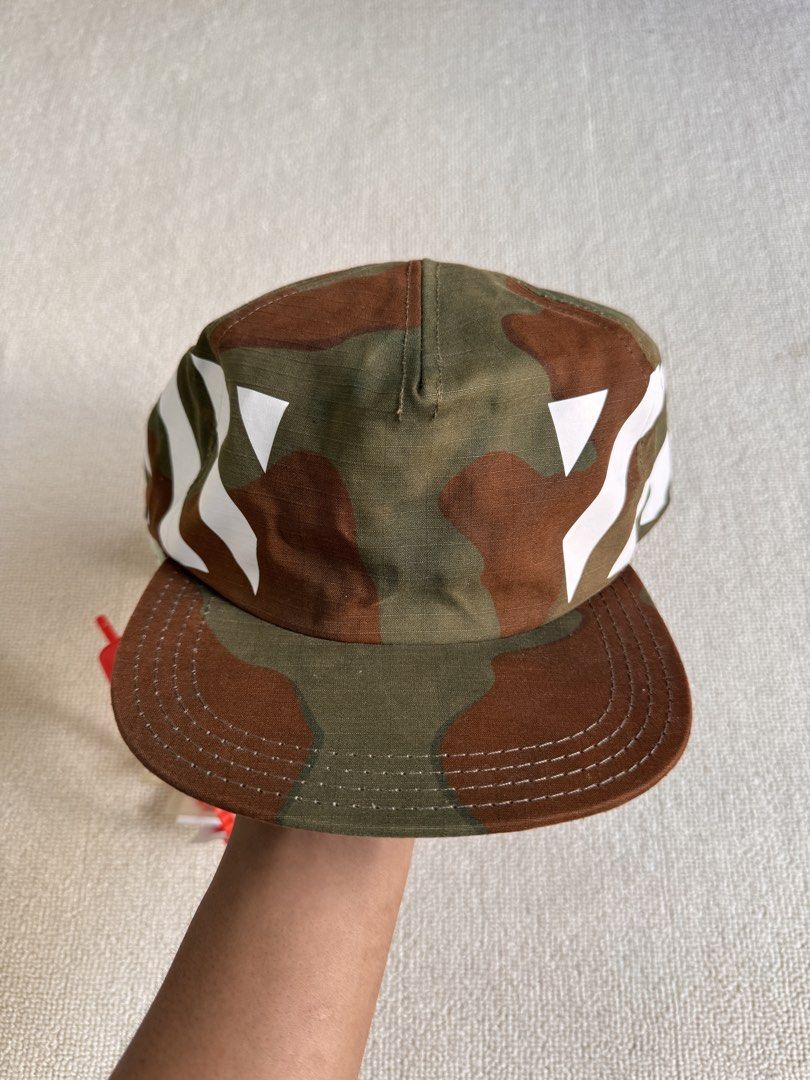 Off-White Camo Cap (Category: Caps & Hats) located in Manila. Submitted by porma.market (Listing ID 1439227845, Image 2). Description: - Authentic Off-White cap - Camouflage pattern - White diagonal stripes - Curved brim - Adjustable strap - Includes original tags - Unworn condition Price : 8,500.