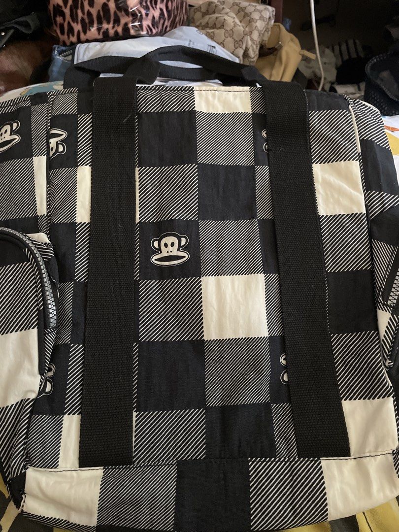 Paul Frank Checkered Tote/laptop Bag (Category: Backpacks) located in Manila. Submitted by goldenphoenix_ac6904 (Listing ID 1439249874, Image 2). Description: - Paul Frank backpack - Black and white checkered pattern - Adjustable shoulder straps with white buckles - Top handle for carrying - Gray interior with a small pocket - Paul Frank logo visible.