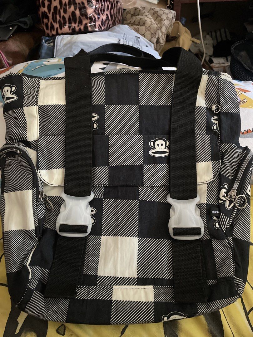 Paul Frank Checkered Tote/laptop Bag (Category: Backpacks) located in Manila. Submitted by goldenphoenix_ac6904 (Listing ID 1439249874, Image 1). Description: - Paul Frank backpack - Black and white checkered pattern - Adjustable shoulder straps with white buckles - Top handle for carrying - Gray interior with a small pocket - Paul Frank logo visible.
