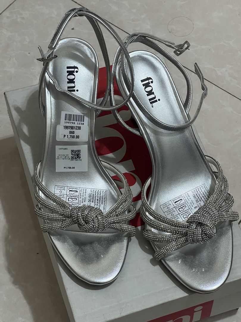 Payless Fioni Silver Heels Sandals (Category: Heels) located in Cavite. Submitted by thingzx (Listing ID 1439146683, Image 1). Description: From Payless. Brand new with box. Just tried them on. Size 6/23cm. Heel height 7cm. Last price posted. Half off na yan, check the sticker tag. Shipping c/o buyer. Can ship nationwide or do same day from Cavite. Payment via Gcash/Maribank/BDO. RFS: Doesn't fit; too small..