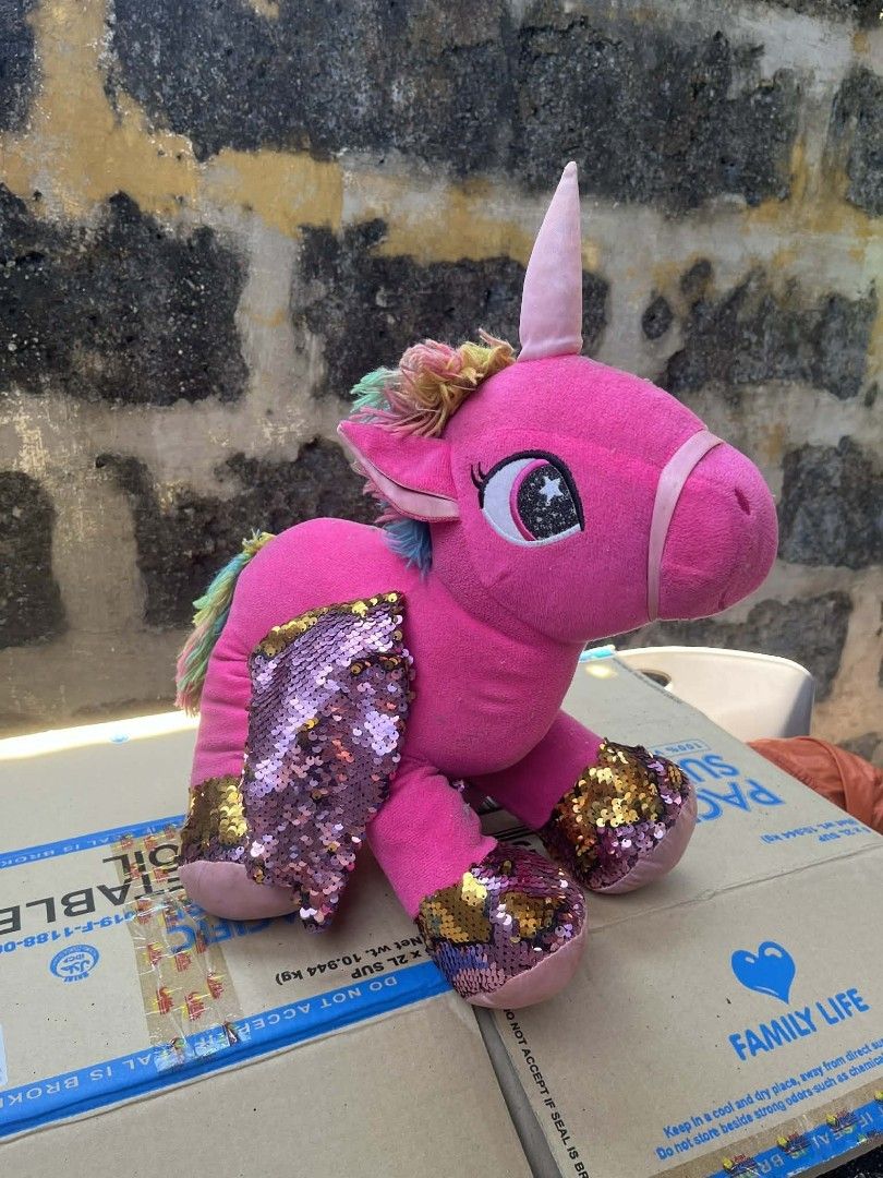 Pink Unicorn Stuffed Toy with Sequins (Category: Toys & Games) located in Muntinlupa City. Submitted by relovemycloset (Listing ID 1439112203, Image 1). Description: - Adorable pink unicorn plush toy - Features a pink horn, mane, and tail with colorful accents - Shimmering sequin wings and feet - Perfect for kids or collectors.