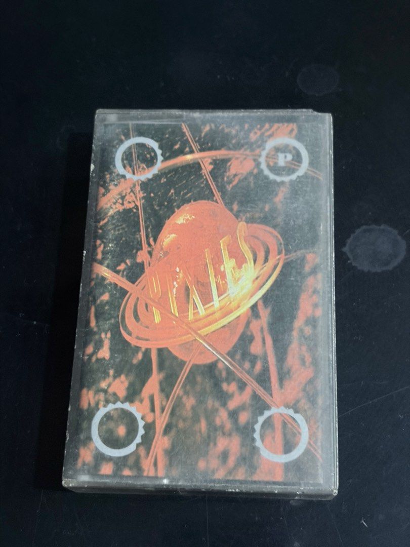Pixies - Bossanova Cassette Tape (Category: CDs & DVDs) located in Tabaco. Submitted by cinemahilig (Listing ID 1439165661, Image 1). Description: - Original Pixies "Bossanova" cassette tape - Comes in its original case - Album title and band name visible - Case features album artwork - Cassette tape labeled CAD C0010.