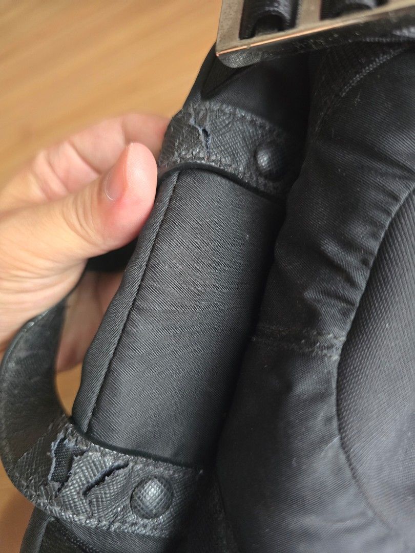 Prada Black Nylon Backpack (Category: Luxury Bags & Wallets) located in Pasig City. Submitted by yoyosstore (Listing ID 1439077136, Image 3). Description: - Authentic Prada backpack - Multiple compartments for storage - Top handle and adjustable straps - Prada logo on the side and inside - Interior zippered pocket - Buckle closures on sides and bottom - Minor wear on handle due to storage - No tear or damage. Very good condition, RFS decluttering