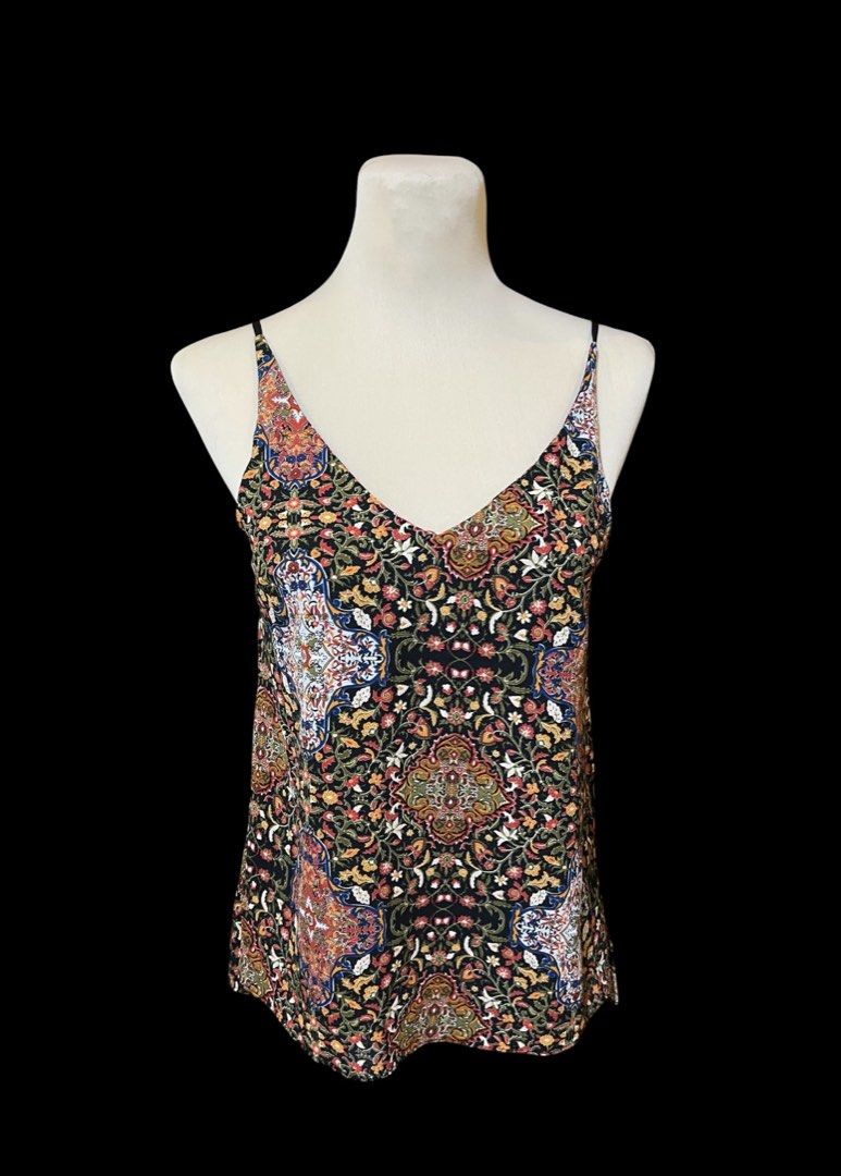 Printed V-Neck Cami Top (Category: Sleeveless) located in Quezon City. Submitted by letsdeclutter101 (Listing ID 1439103272, Image 3). Description: - Printed cami top - V-neck design - Features thin straps - Made with lightweight fabric - Relaxed fit - Straight hemline - Suitable for warm weather - Versatile for various outfits.