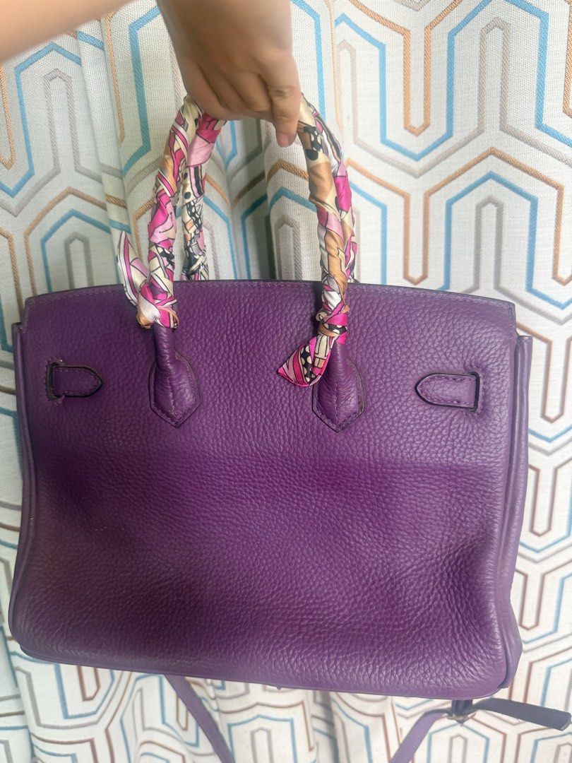 Purple Leather Handbag with Scarf Handle (Category: Shoulder Bags) located in Taguig. Submitted by che_f25 (Listing ID 1439094832, Image 2). Description: - Purple leather handbag - Gold-tone hardware - Top handle with patterned scarf - Detachable shoulder strap - Multiple interior compartments - Zippered pocket inside - Structured shape - Flap closure with buckle details - Textured leather finish.