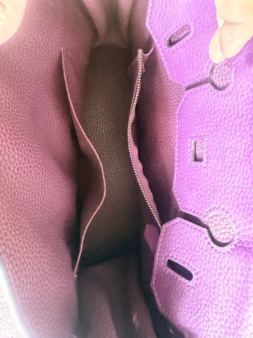 Purple Leather Handbag with Scarf Handle (Category: Shoulder Bags) located in Taguig. Submitted by che_f25 (Listing ID 1439094832, Image 3). Description: - Purple leather handbag - Gold-tone hardware - Top handle with patterned scarf - Detachable shoulder strap - Multiple interior compartments - Zippered pocket inside - Structured shape - Flap closure with buckle details - Textured leather finish.