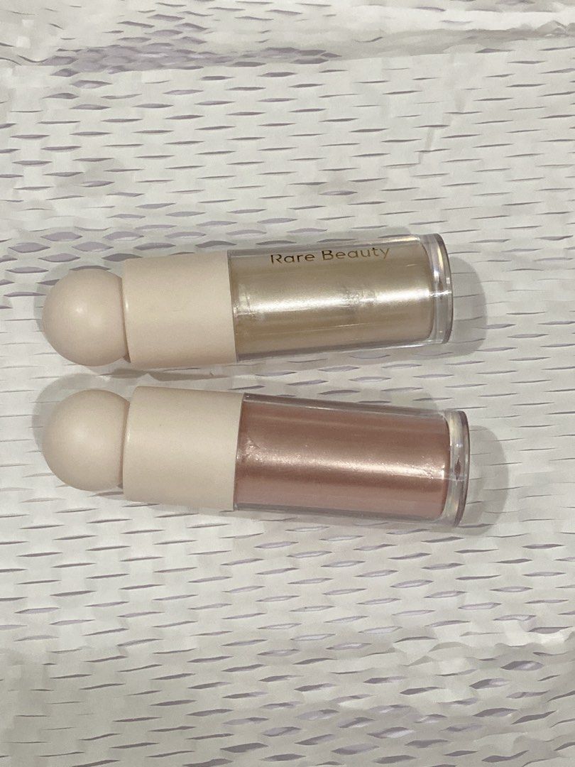 Rare Beauty Liquid Luminizer Highlighters (Category: Makeup) located in Del Monte. Submitted by pageturner_digital (Listing ID 1439238434, Image 1). Description: - Rare Beauty Liquid Luminizers for sale. - Enlighten and Mesmerize - EnlightenI used on the side of my eye, and collar bone - Mesmerize I used on my cheeks. - Authentic product. - Price is for each - RFS: Will transfer to DIOR which I already have. - 80% Full still with a box..