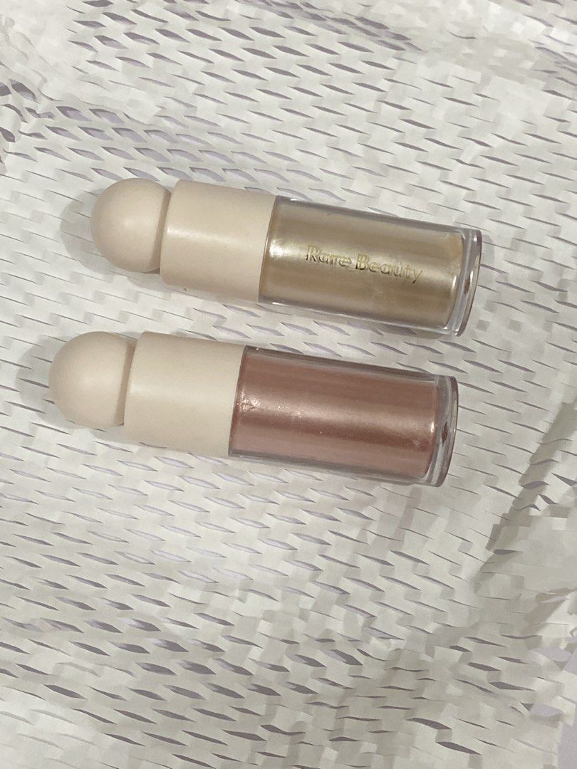 Rare Beauty Liquid Luminizer Highlighters (Category: Makeup) located in Del Monte. Submitted by pageturner_digital (Listing ID 1439238434, Image 2). Description: - Rare Beauty Liquid Luminizers for sale. - Enlighten and Mesmerize - EnlightenI used on the side of my eye, and collar bone - Mesmerize I used on my cheeks. - Authentic product. - Price is for each - RFS: Will transfer to DIOR which I already have. - 80% Full still with a box..
