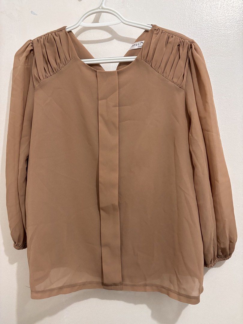 Signature Cloth Brown Blouse (Category: Blouses) located in Quezon City. Submitted by closettreasure123 (Listing ID 1439239900, Image 1). Description: - Signature Cloth brown blouse - Unique back design - Gathered detailing on shoulders - Long sleeves with elastic cuffs - Lightweight, flowing fabric - Suitable for casual and semi-formal occasions.