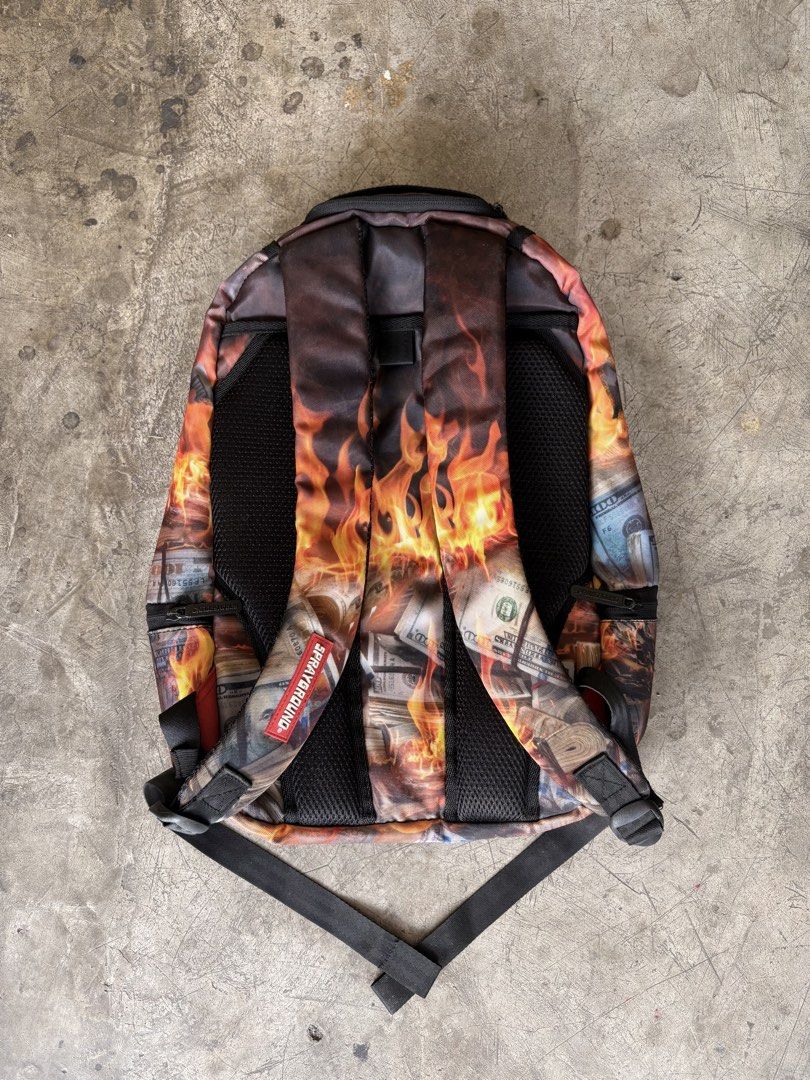 sprayground burning money backpack (Category: Backpacks) located in Manila. Submitted by ykwtfgon (Listing ID 1439088346, Image 2). Description: Sprayground burning money backpack lightly used 10/10 condition 3000php meetups around metromanila if shipping any courier will do .