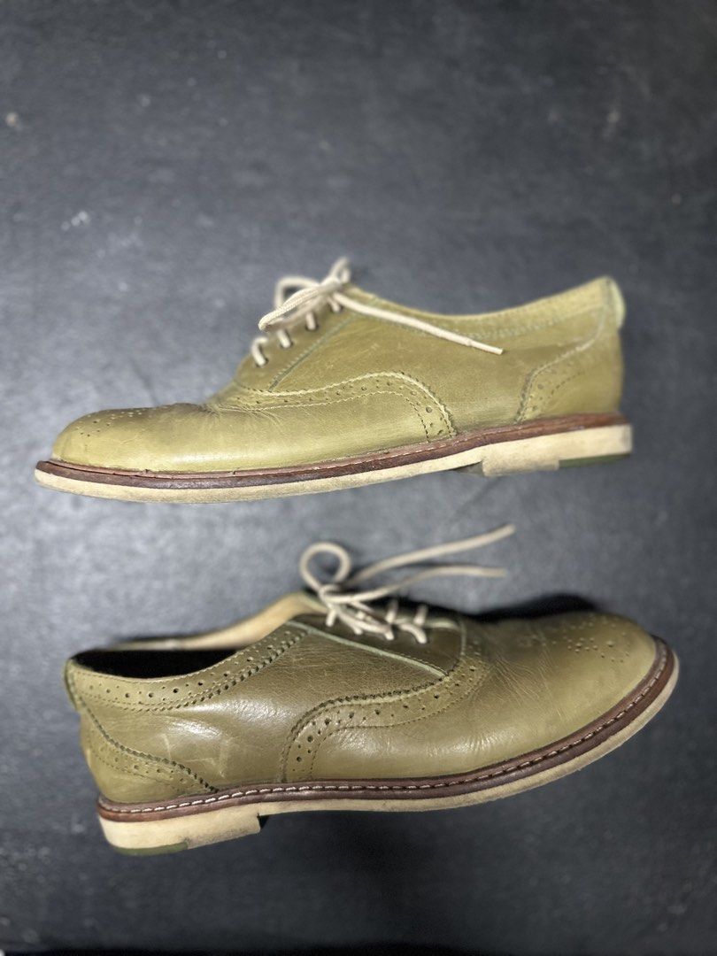 UGG Oxford Shoes - Green (Category: Loafers) located in Quezon City. Submitted by plzdeclutter (Listing ID 1439216547, Image 1). Description: These UGG Oxford shoes feature a classic design with a green leather upper. They have a lace-up closure and a perforated toe cap. The soles show some wear, and the UGG logo is visible on the insole and sole. The shoes appear to be well-maintained and ready for wear..