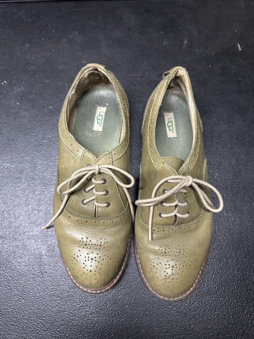 UGG Oxford Shoes - Green (Category: Loafers) located in Quezon City. Submitted by plzdeclutter (Listing ID 1439216547, Image 2). Description: These UGG Oxford shoes feature a classic design with a green leather upper. They have a lace-up closure and a perforated toe cap. The soles show some wear, and the UGG logo is visible on the insole and sole. The shoes appear to be well-maintained and ready for wear..