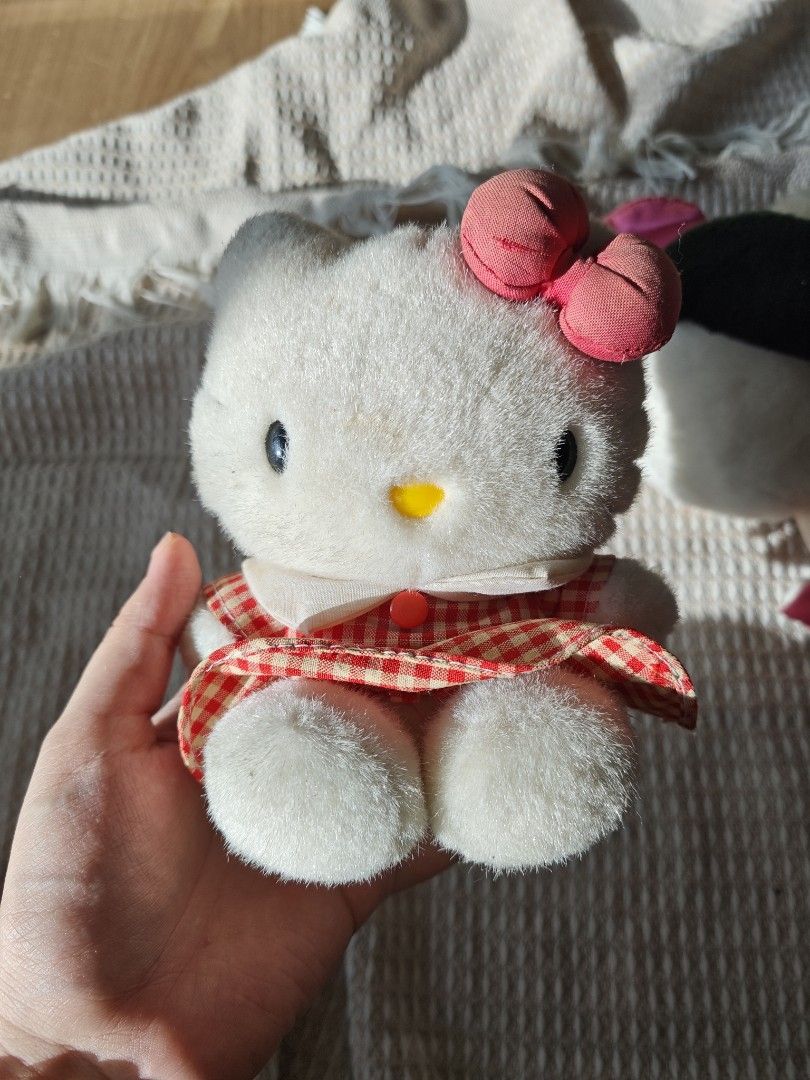 Vintage Sanrio Hello Kitty Plush Toy (Category: Toys & Games) located in Caloocan City. Submitted by luckyrabbit-d68b (Listing ID 1439152730, Image 1). Description: - Adorable vintage Hello Kitty plush toy. - Classic white body. - Red and white checkered dress. - Pink bow. - Yellow nose and black eyes. - Includes original Sanrio tag. - Perfect for collectors!.