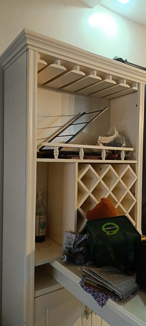 White Wooden Bar Cabinet (Category: Shelves, Cabinets & Racks) located in Pasig City. Submitted by kimjose (Listing ID 1439242076, Image 3). Description: - Elegant white wooden bar cabinet - Includes wine rack and glass holders - Features a pull-out counter - Cabinet doors with interior shelving - Ideal for storing beverages and barware - Perfect for home entertainment.