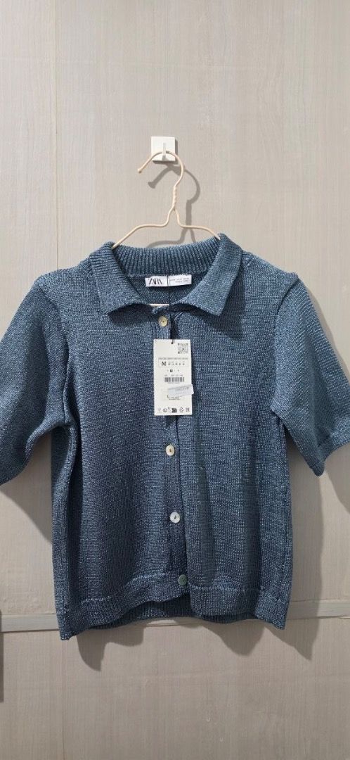 Zara Blue Knit Cardigan (Category: Blouses) located in Cabuyao City. Submitted by grae__ (Listing ID 1439243871, Image 3). Description: - Zara cardigan - Collared neckline - Short sleeves - Button-down closure - Textured knit fabric - Brand new with Tag. - Have some fluff due to storage. Never worn..
