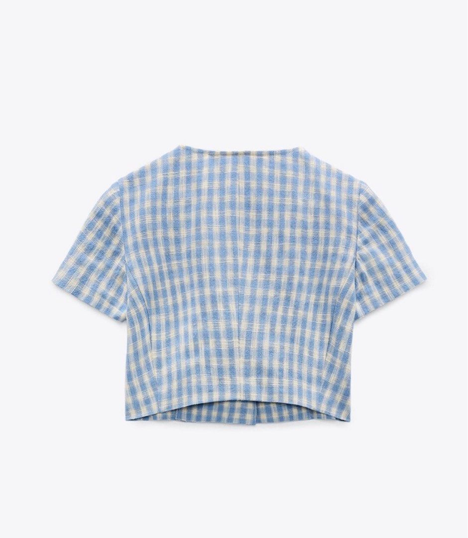 Zara Gingham Crop Top (Category: Sleeveless) located in Quezon City. Submitted by _dcluttering (Listing ID 1439183107, Image 2). Description: - Zara crop top - Classic blue and white gingham pattern - Square neckline - Short sleeves - Button-down front with two small pockets - Cropped length - Stylish and versatile.