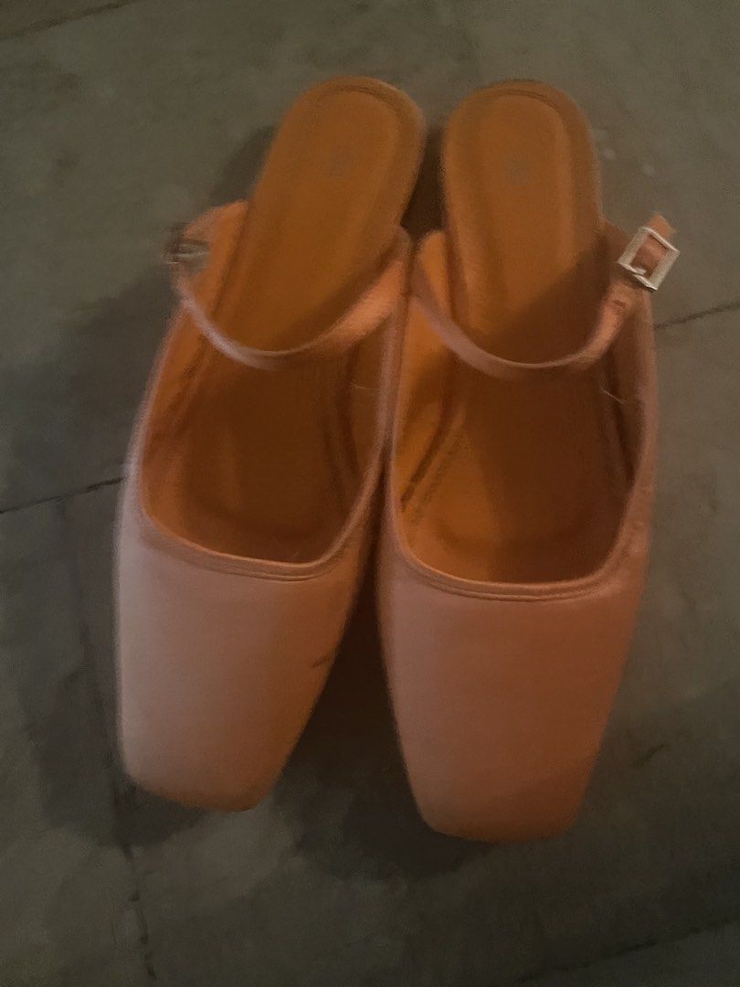 Zara Orange Square Toe Mules (Category: Flats & Sandals) located in Quezon City. Submitted by deadmit (Listing ID 1439069783, Image 2). Description: These Zara mules feature a square toe design and an orange color. They have a strap around the ankle with a buckle closure. The shoes have a low heel and the Zara logo is visible on the insole. The soles are black..