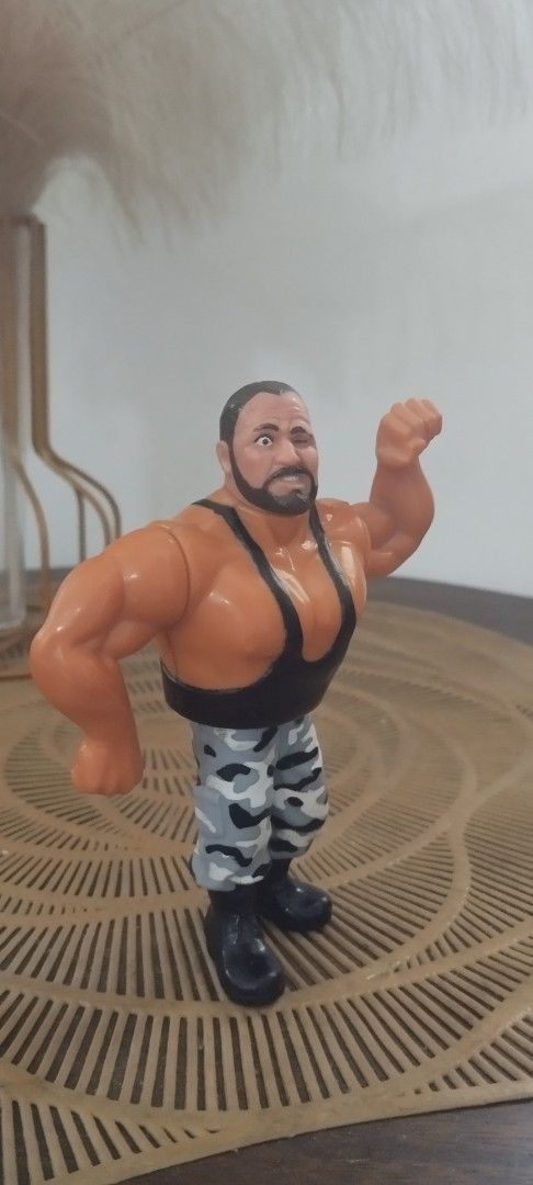 1991 Hasbro WWF Bushwacker Butch action figure (Category: Action & Battle Toys) located in Manila. Submitted by ventajetoyz625 (Listing ID 1439281740, Image 2). Description: - Vintage wrestling action figure - Muscular wrestler design - Black tank top and camouflage pants - Detailed with a beard - Flexing arm pose - Made of plastic - "Gimmick" not working - What you see is what you get.