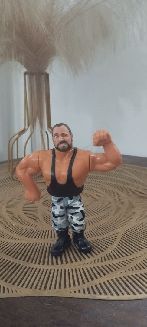 1991 Hasbro WWF Bushwacker Butch action figure (Category: Action & Battle Toys) located in Manila. Submitted by ventajetoyz625 (Listing ID 1439281740, Image 1). Description: - Vintage wrestling action figure - Muscular wrestler design - Black tank top and camouflage pants - Detailed with a beard - Flexing arm pose - Made of plastic - "Gimmick" not working - What you see is what you get.