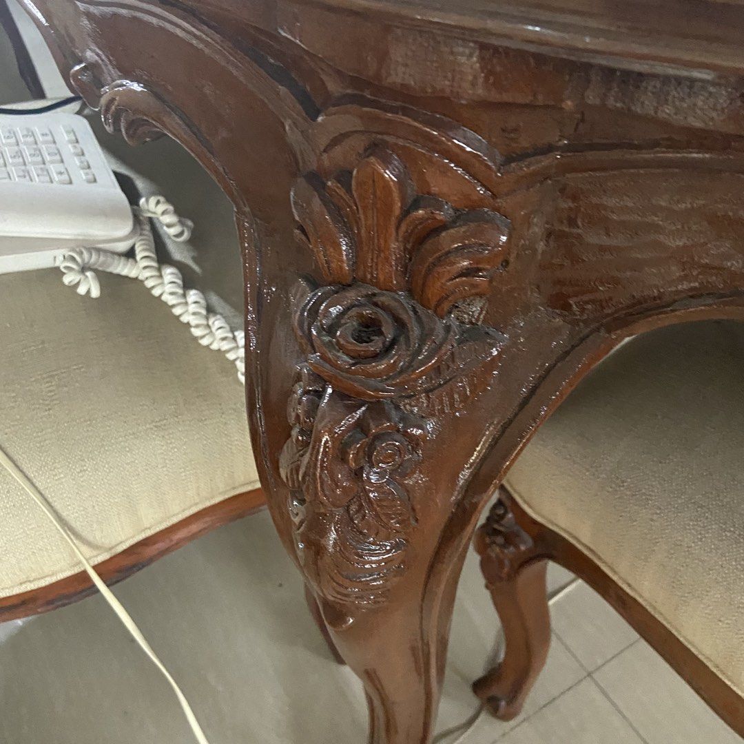 Vintage Wooden Dining Table with Chairs (Category: Tables & Sets) located in Paranaque City. Submitted by furniture_seller_jay (Listing ID 1439278599, Image 3). Description: Hardwood dining table set with 6 chairs. Heavy. Please be advised that two of the chairs are upholstered differently. Elegant antique dining table set. Features a large oval wooden table with intricately carved details on the legs and edges. Includes chairs with upholstered b