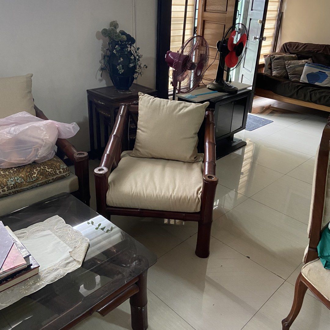 Bamboo Sofa Set with Coffee Table (Category: Sofas) located in Paranaque City. Submitted by furniture_seller_jay (Listing ID 1439279068, Image 2). Description: Very heavy bamboo sofa set. - Bamboo sofa set includes: three-seater sofa, two armchairs, and a square coffee table. - Features a glass-topped coffee table. - Comes with beige cushions. - Sofa has a patterned seat cushion. - Dark bamboo frame finish. - Perfect for living room or lanai spac