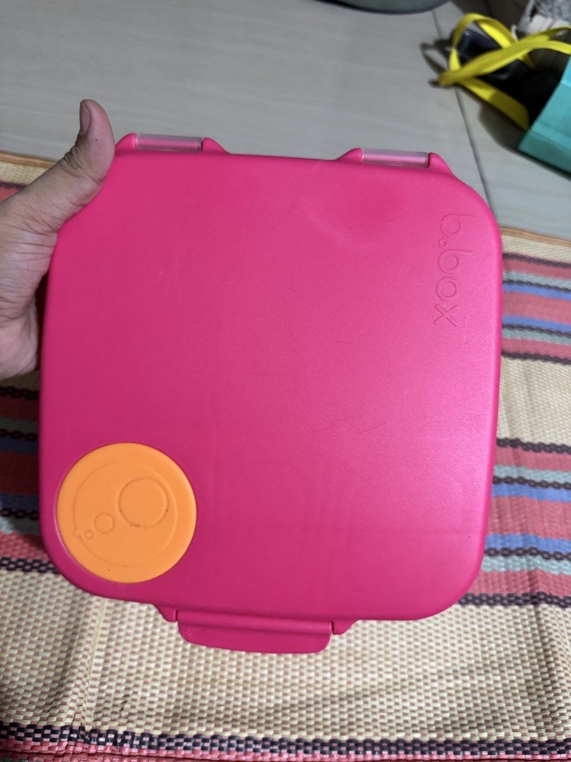b.box Lunchbox - Pink (Category: Food Organization & Storage) located in Dasmarinas. Submitted by bookcollection27 (Listing ID 1439315176, Image 1). Description: B.box lunchbox in pink with orange accents. Features multiple compartments for different food items. Includes a handle for easy carrying. The lunchbox has a secure closing mechanism. The interior includes a removable divider and a small container. The exterior has the b.box logo. (gel ic