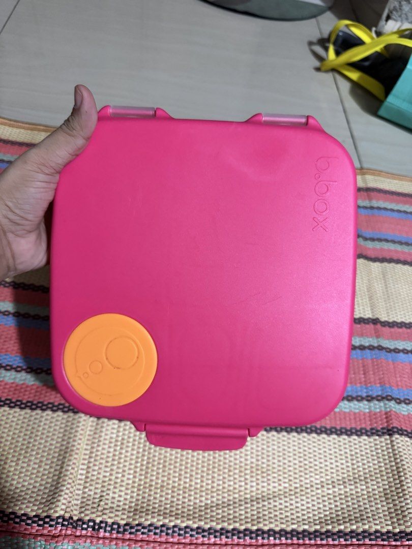 b.box Lunchbox - Pink (Category: Food Organization & Storage) located in Dasmarinas. Submitted by bookcollection27 (Listing ID 1439315176, Image 3). Description: B.box lunchbox in pink with orange accents. Features multiple compartments for different food items. Includes a handle for easy carrying. The lunchbox has a secure closing mechanism. The interior includes a removable divider and a small container. The exterior has the b.box logo. (gel ic