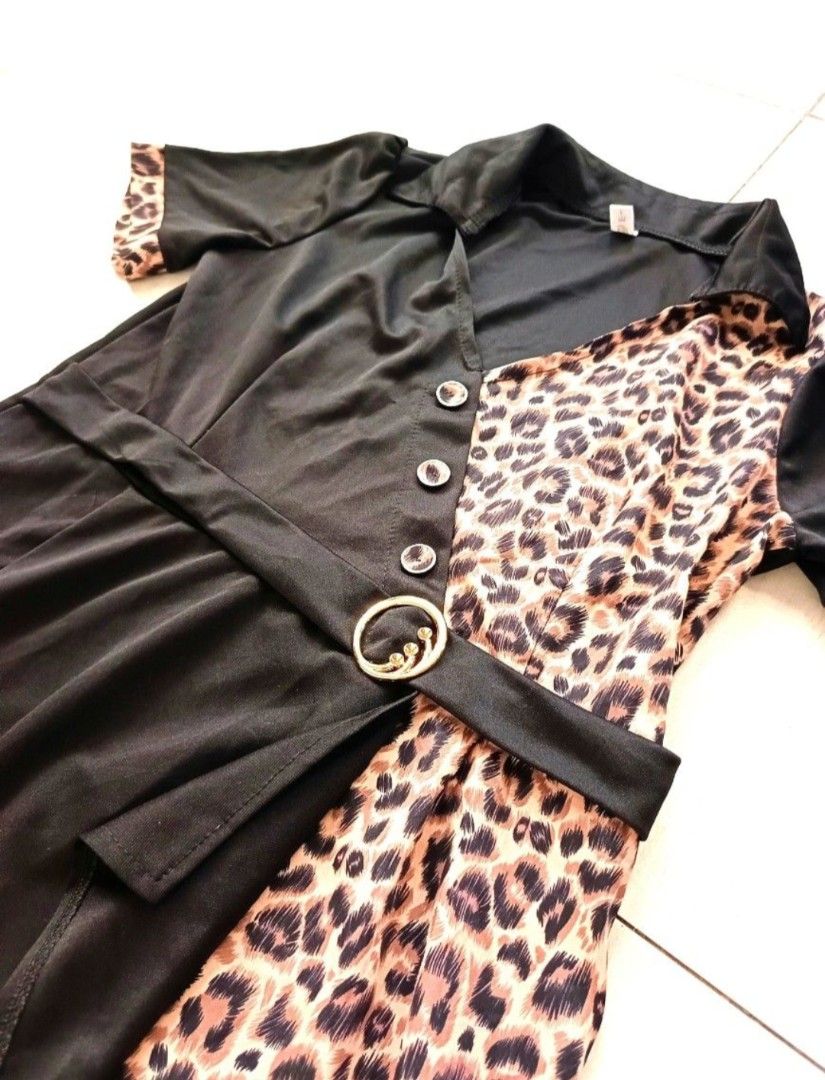 Black and Leopard Print Dress (Category: Dresses) located in Quezon City. Submitted by minimalista_ph2023 (Listing ID 1439252315, Image 2). Description: Casual Sunday Dress • Size: Medium frames Price: Php 199 only! Location: Diliman, Quezon City Unique black and leopard print design - Short sleeves - Collared neckline - Includes a belt with gold buckle - Button-down front - Wrap-style skirt - Made of soft, flowing fabric.
