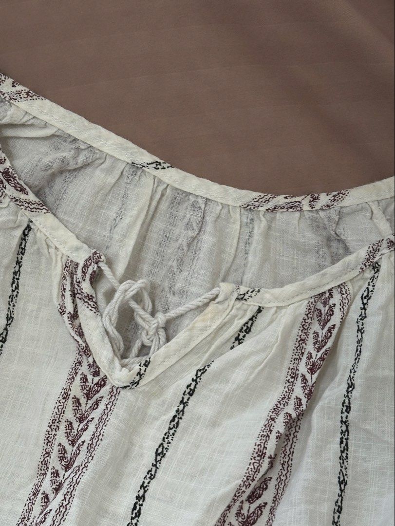 Bohemian White Dress (Category: Dresses) located in Davao. Submitted by beys.corner (Listing ID 1439337824, Image 3). Description: - Bohemian style white dress - V-neckline with tie detail - Short sleeves - Tiered skirt - Vertical striped pattern - Embroidered accents (brown and black) - Lightweight fabric.
