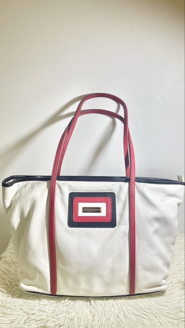 Bruno Magli White Leather Tote Bag (Category: Tote Bags) located in Makati City. Submitted by eileencruz (Listing ID 1439348956, Image 1). Description: - Elegant Bruno Magli tote bag - White leather with red accents - Secure zip closure - Rectangular logo patch - Red handles and trim - Stylish and functional for everyday use.