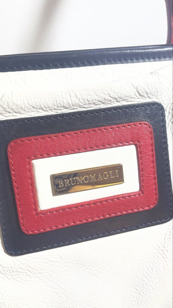 Bruno Magli White Leather Tote Bag (Category: Tote Bags) located in Makati City. Submitted by eileencruz (Listing ID 1439348956, Image 2). Description: - Elegant Bruno Magli tote bag - White leather with red accents - Secure zip closure - Rectangular logo patch - Red handles and trim - Stylish and functional for everyday use.