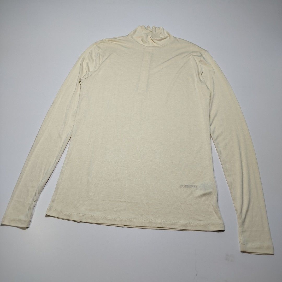 Burberry Silk Knit Mock Neck Zip Top (Category: Longsleeves) located in Manila. Submitted by mnlhappybattle (Listing ID 1439313846, Image 1). Description: Burberry Silk Knit Mock Neck Zip Top ​Elevate your wardrobe with this ultra-luxurious, lightweight mock neck top from Burberry London England. Crafted in Portugal from premium 100% silk, this piece offers an incredibly soft, fluid drape with a subtle, sophisticated sheen. It features a sleek ha