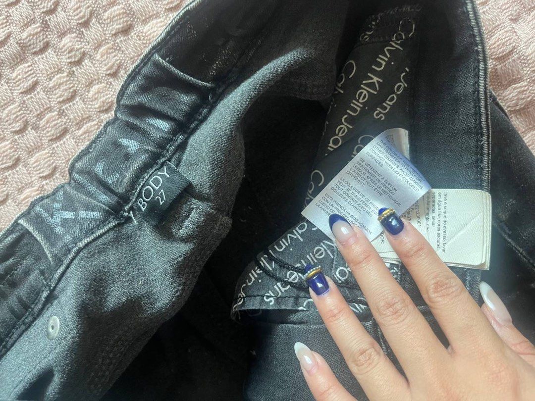 Calvin Klein Jeans Body Size 27 (Category: Jeans) located in Mandaluyong City. Submitted by beangoose (Listing ID 1439401927, Image 2). Description: - Black Calvin Klein Jeans - Size: 27 - Distressed style - Features a tear on the knee - Classic five-pocket design - Button and zipper closure - Calvin Klein Jeans logo visible.