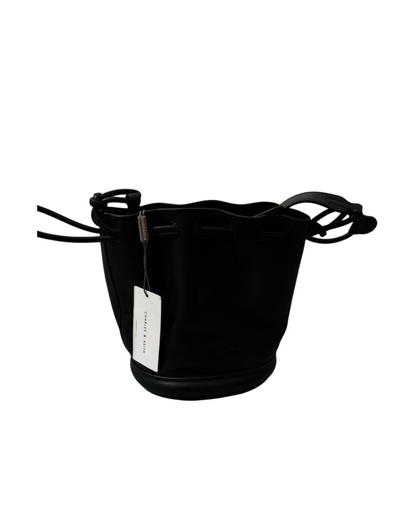 Charles & Keith Blossom Drawstring Bucket Bag - Black (Category: Cross-body Bags) located in Paranaque City. Submitted by macadamia31 (Listing ID 1439292343, Image 2). Description: - Charles & Keith Blossom Drawstring Bucket Bag - Color: Black - Features: - Drawstring closure - Detachable shoulder strap - Embossed Charles & Keith logo - Includes original tag - Item number: CK2-10271018_BLACK_S.