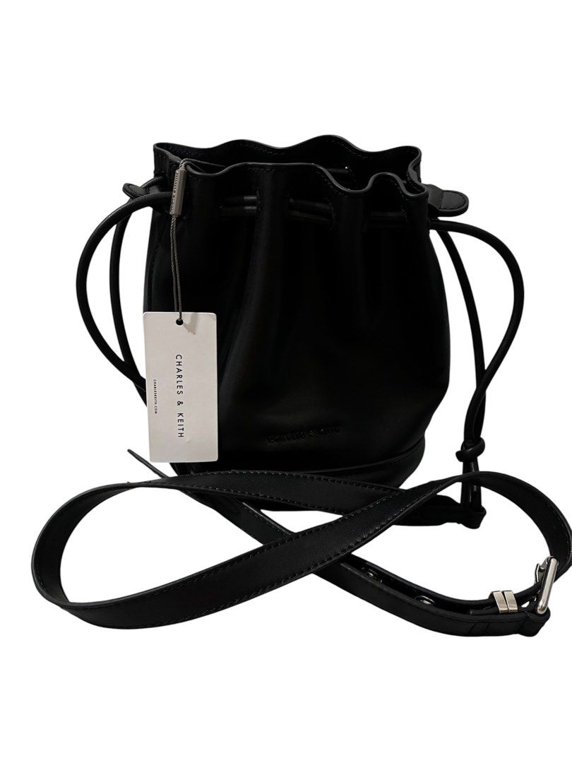 Charles & Keith Blossom Drawstring Bucket Bag - Black (Category: Cross-body Bags) located in Paranaque City. Submitted by macadamia31 (Listing ID 1439292343, Image 1). Description: - Charles & Keith Blossom Drawstring Bucket Bag - Color: Black - Features: - Drawstring closure - Detachable shoulder strap - Embossed Charles & Keith logo - Includes original tag - Item number: CK2-10271018_BLACK_S.