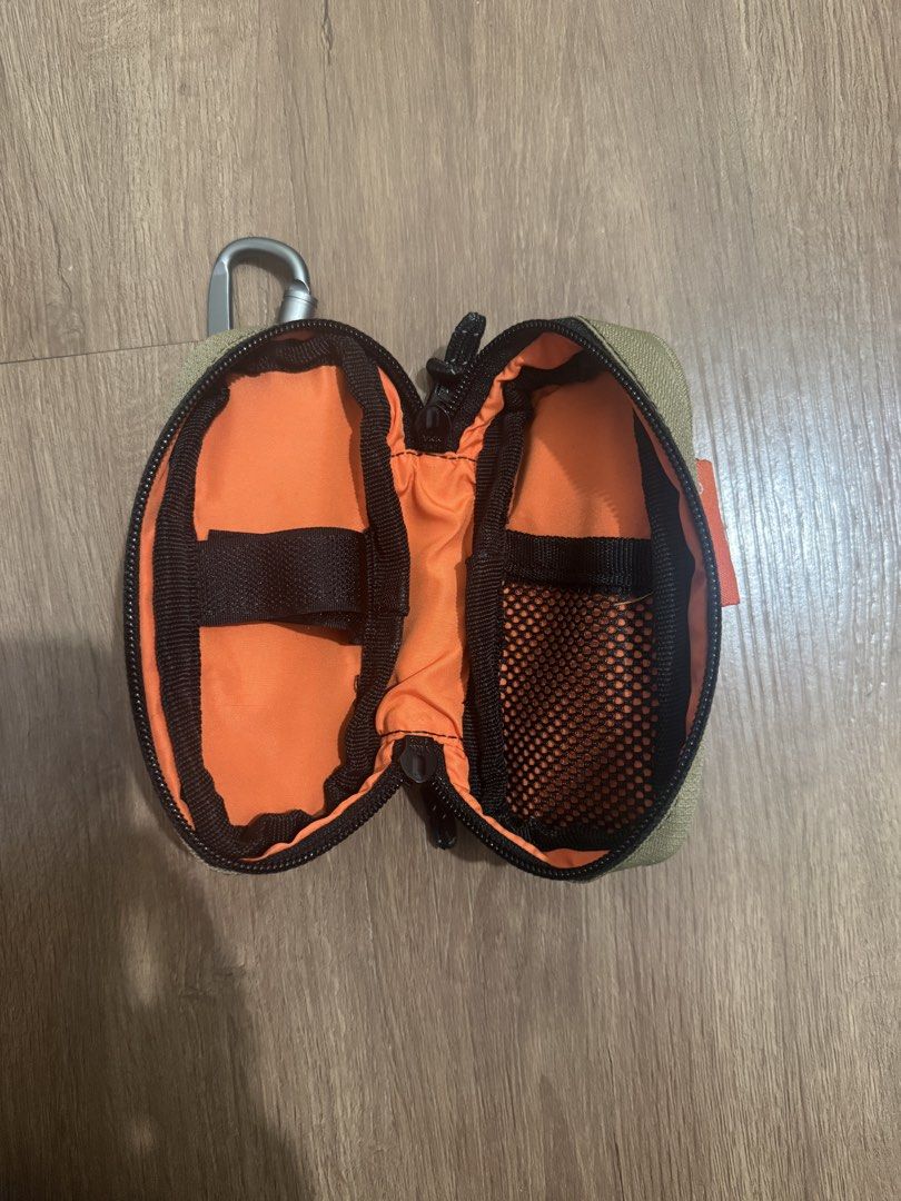 City creatures Pouch with Carabiner (Category: Purses & Pouches) located in Valenzuela. Submitted by fairythrift (Listing ID 1439346143, Image 3). Description: - Citycreatures pouch for small essentials. - Includes a mesh pocket and internal strap for organization. - Convenient carabiner for easy attachment. - Stylish tan exterior with a vibrant orange interior. - Secure zipper closure. - Features a small Citycreatures tag. This compact, speciali