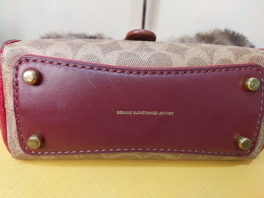 Coach Tabby Cherry Bag (Category: Luxury Bags & Wallets) located in Malabon City. Submitted by jullie_bag_shop (Listing ID 1439282544, Image 3). Description: - Coach Tabby bag with a charming cherry charm. - Features a detachable strap for versatile wear. - Signature pattern on the front. - Burgundy leather flap and base. - Gold-toned feet. - Top handle and secure zipper closure. - Interior includes a leather tag with Coach logo and serial number